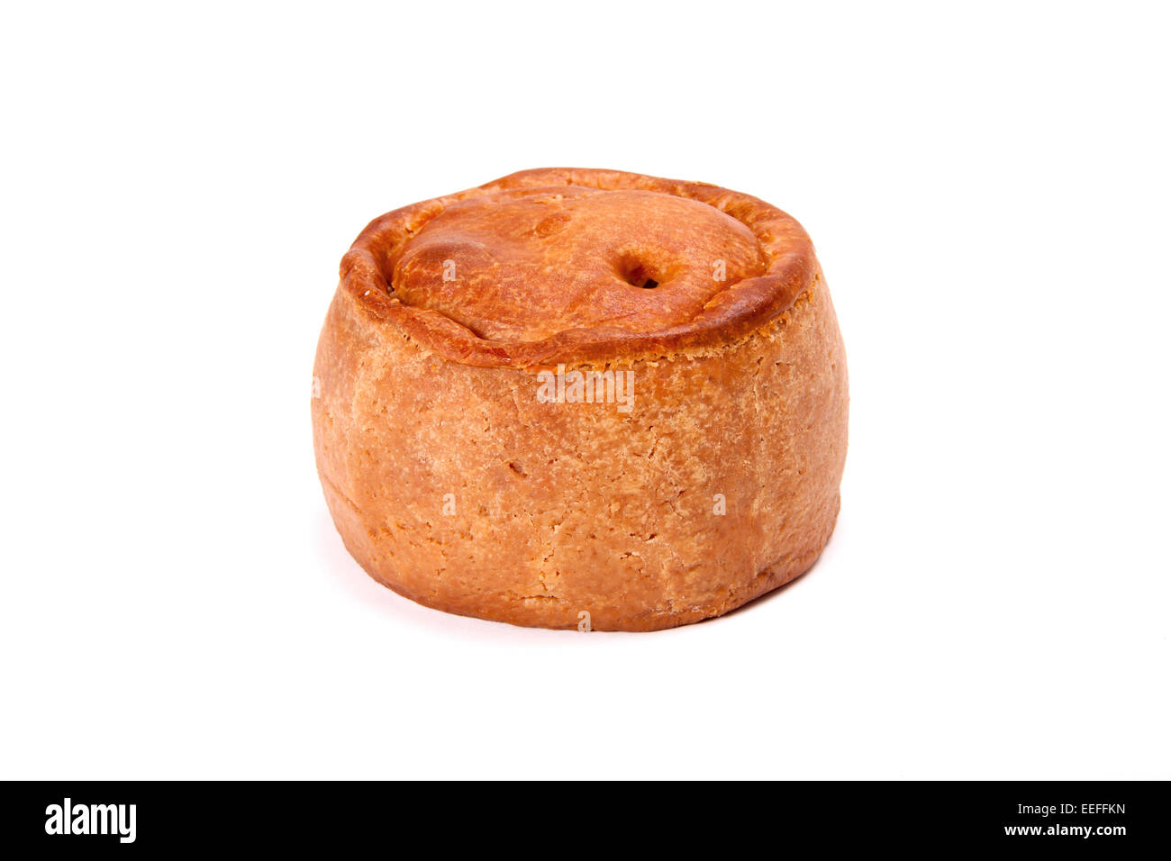A traditional British pork pie on a white background. Stock Photo