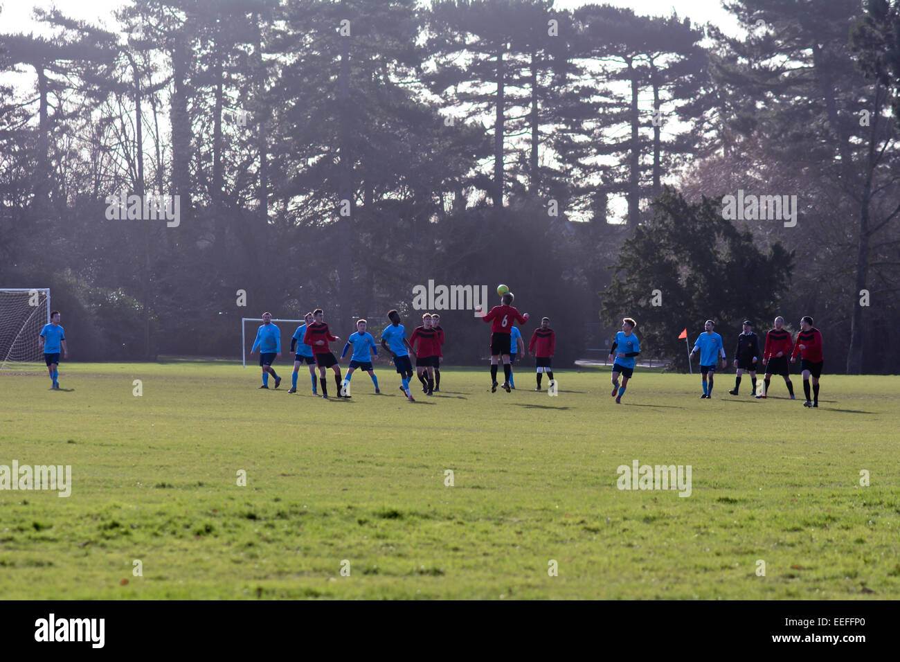 Two teams playing football in Bedford park, Bedford, Bedfordshire, England Stock Photo