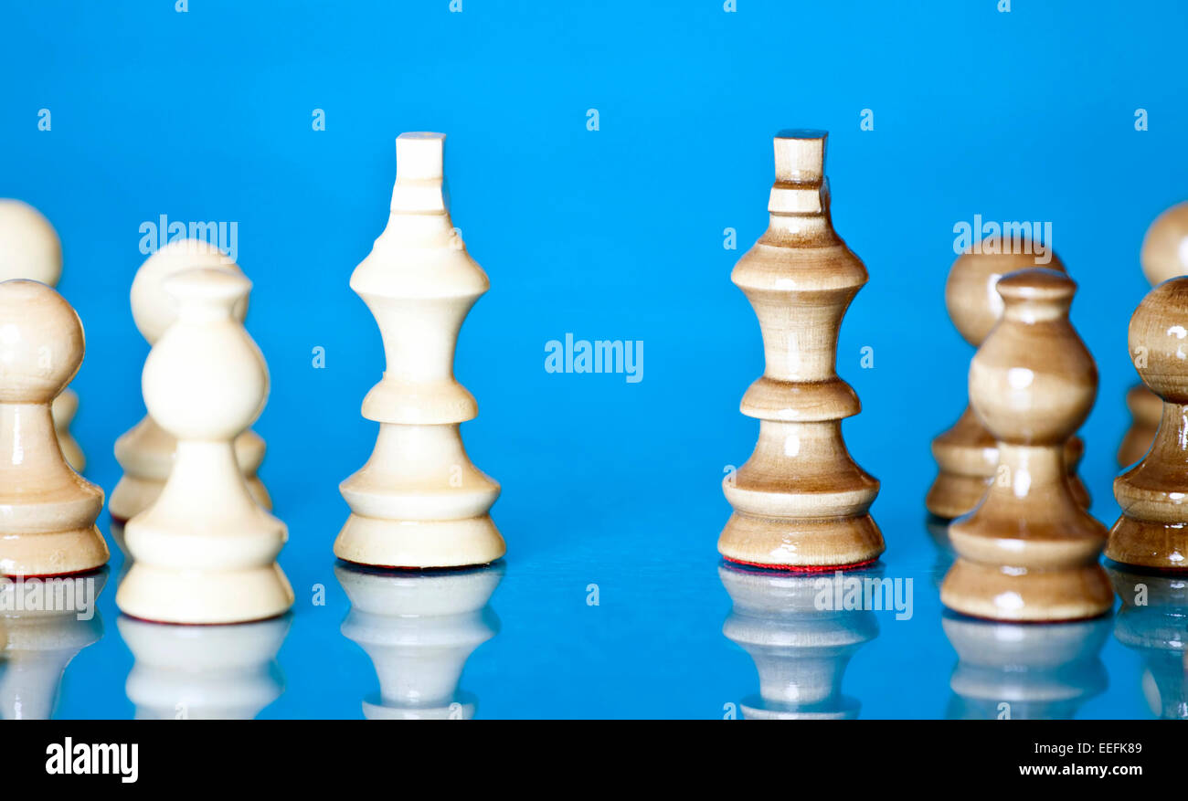 Chess pieces on blue background Stock Photo - Alamy