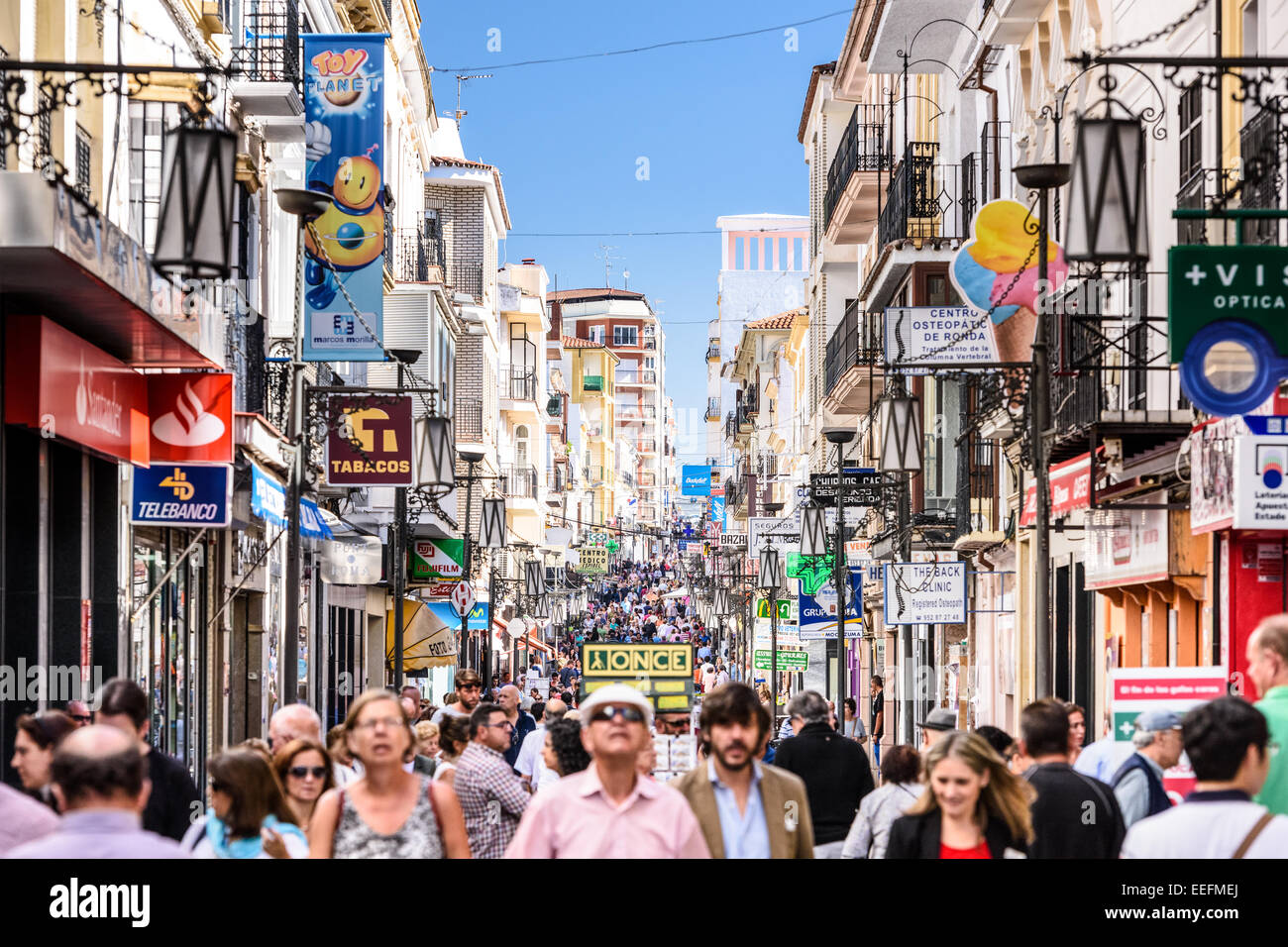 RONDA, SPAIN - OCTOBER 5, 2014: Crowds walk on Calle La Bola (Carretera Espinel) pedestrian street in Ronda. Stock Photo