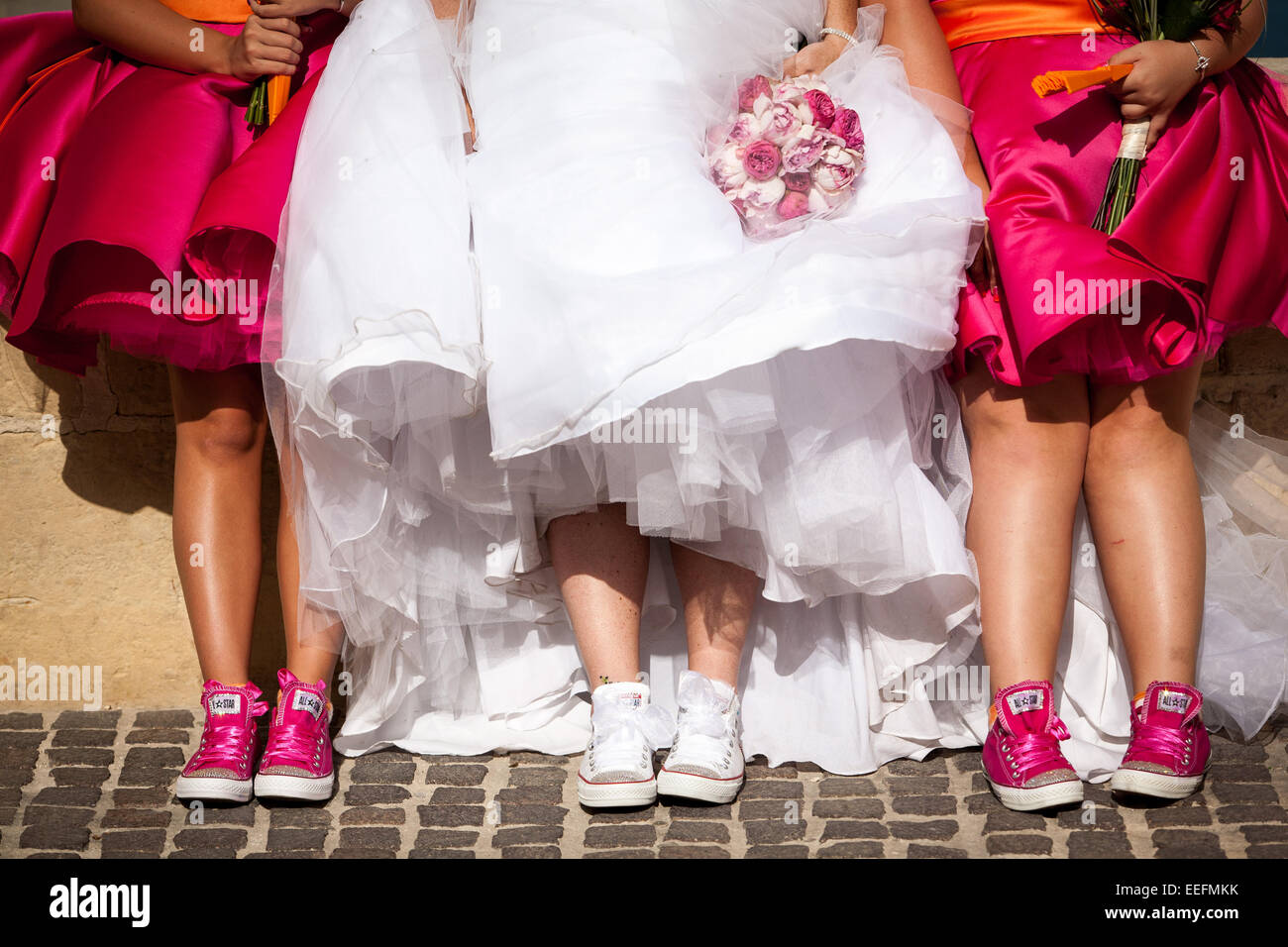bride and her bridesmaids in their wedding trainers Stock Photo