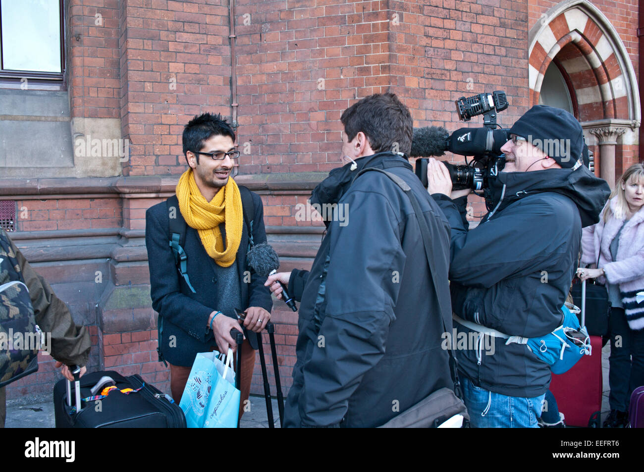 London, UK. 17th Jan, 2015. A passenger is interviewed by a film crew outside St. Pancras starion, London, England, UK, as it is announced that all Eurostar trains are cancelled because of an infrastructure problem (subsequently known to be a lorry fire) in Eurotunnel. Credit:  Julie Fryer/Alamy Live News Stock Photo