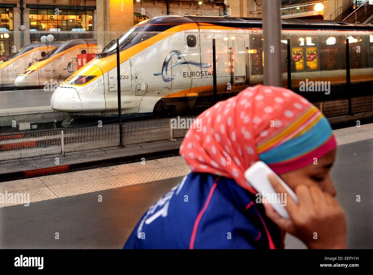 Paris, France. 17th Jan, 2015. A passenger makes a phone call besides a Eurostar train at the Gare du Nord train station in Paris, France, Jan. 17, 2015. All services of Eurostar were suspended Saturday due to smoke detection in the Channel Tunnel, Eurostar announced Saturday. All trains were returning to original stations as the Channel Tunnel linking Britain and France was closed until further notice, Eurostar's customer care team said on its Twitter account. Credit:  Chen Xiaowei/Xinhua/Alamy Live News Stock Photo
