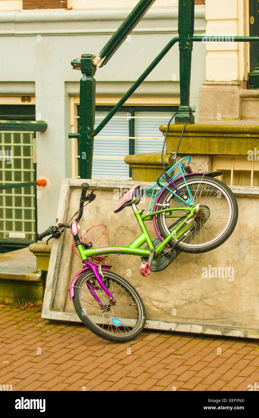 Bicycle chained outside a house in Amsterdam, This is an iconic picture of the most recognizable feature of the Dutch capital. Stock Photo