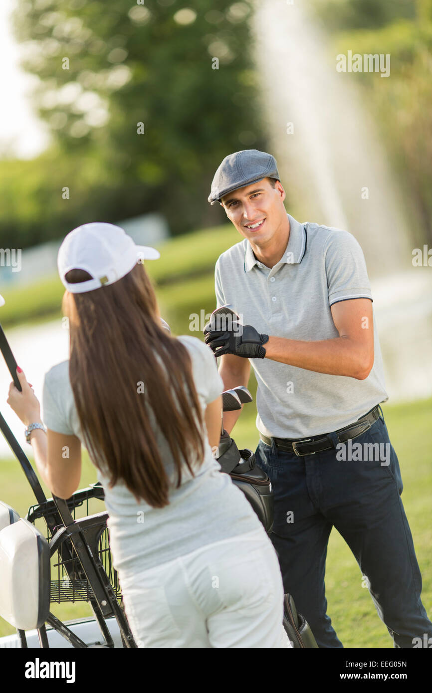 Young couple at golf court Stock Photo