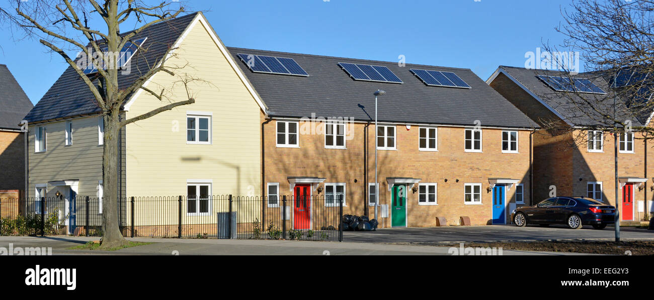 New mixed housing development nearing completion (few occupied some empty) with new solar panels installed during construction Stock Photo
