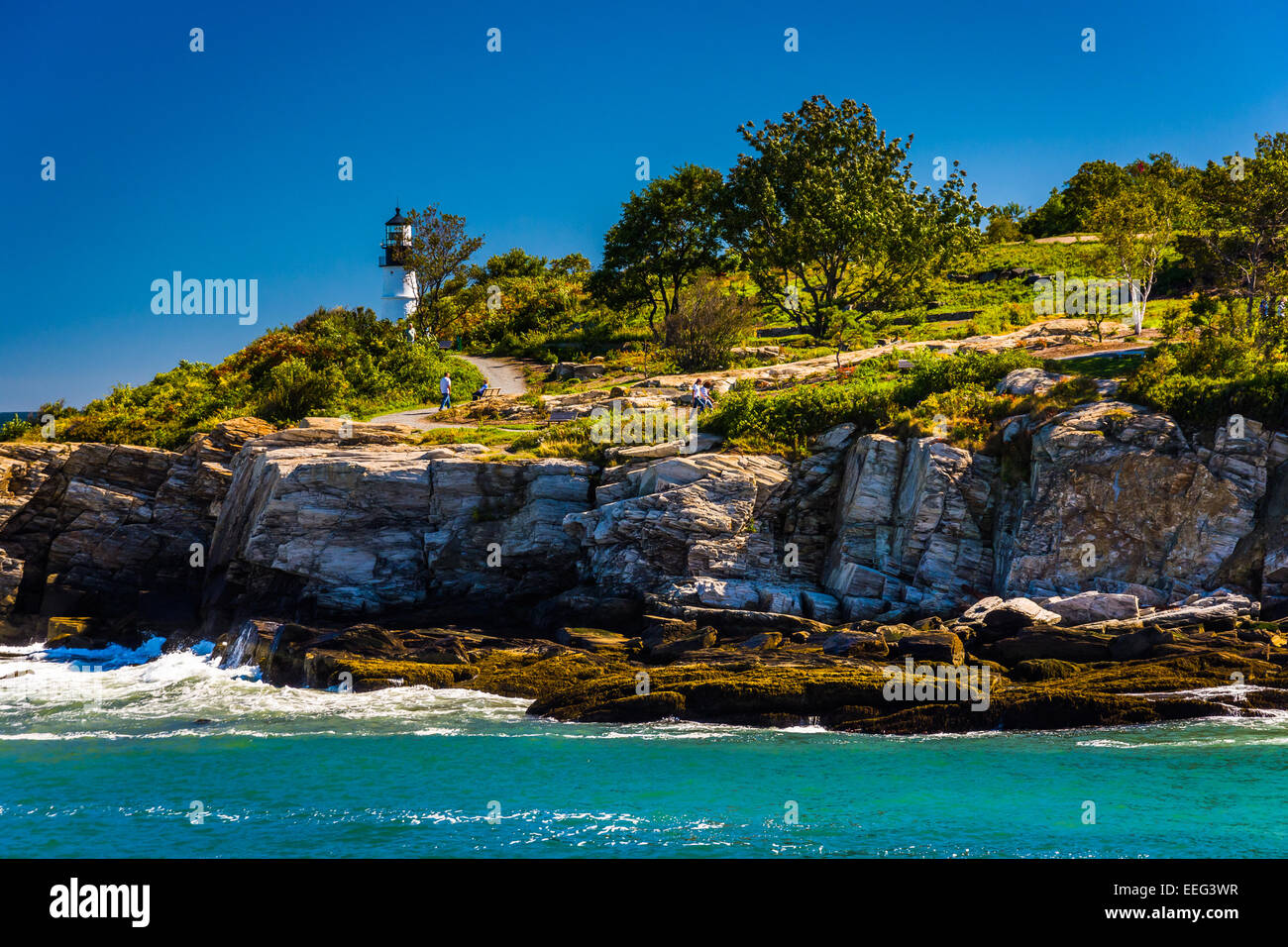 Rocky coast and view of Portland Head Light, at Fort Williams Park, Cape Elizabeth, Maine. Stock Photo