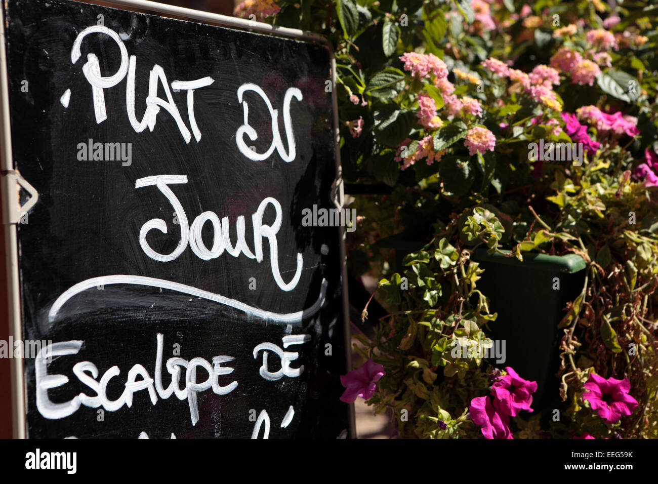 Paris restaurant in France with menu board and flower display. Stock Photo