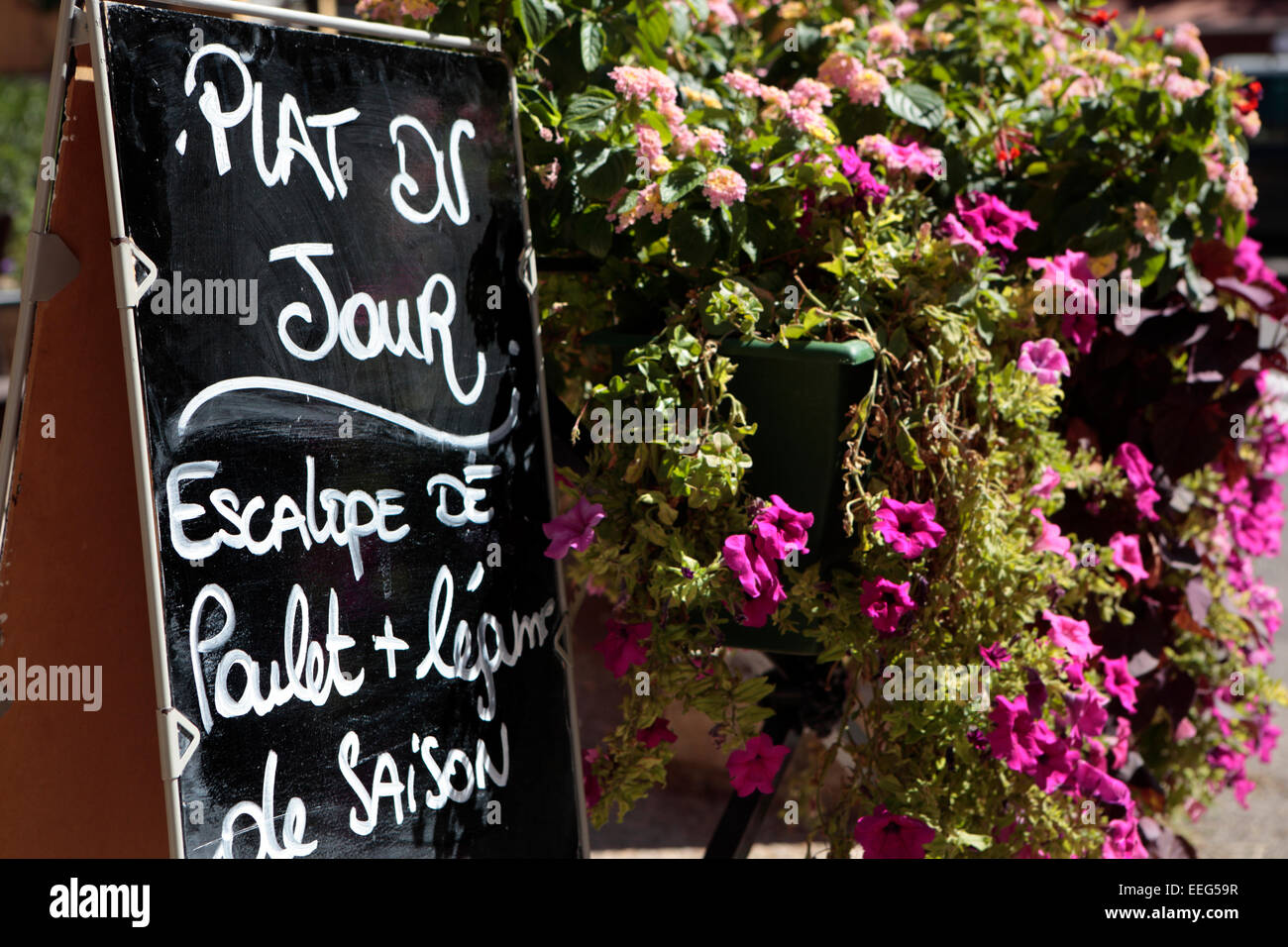 Restaurant in Provence, France with menu board and flower display. Stock Photo
