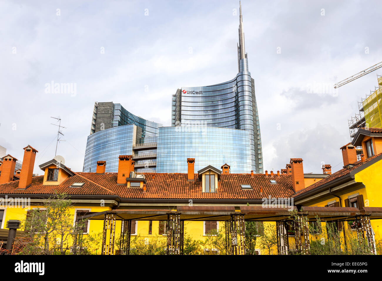 MILAN, ITALY - OCTOBER 15,2014:  Traditional milanese historic house in the foreground with the new modern glass building of Uni Stock Photo