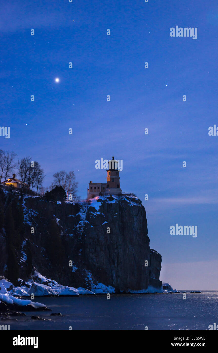 Split Rock Lighthouse glows under the moon on the shore of Lake Superior. Stock Photo