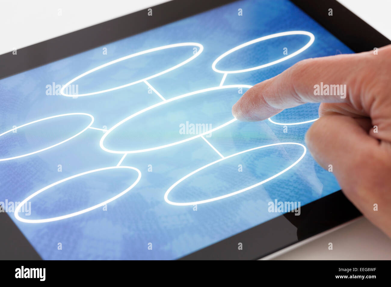 Clicking on a tablet with flow chart Stock Photo