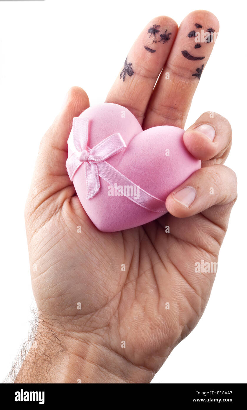 Couple painted on man's fingers and gift box in the form of heart. Stock Photo