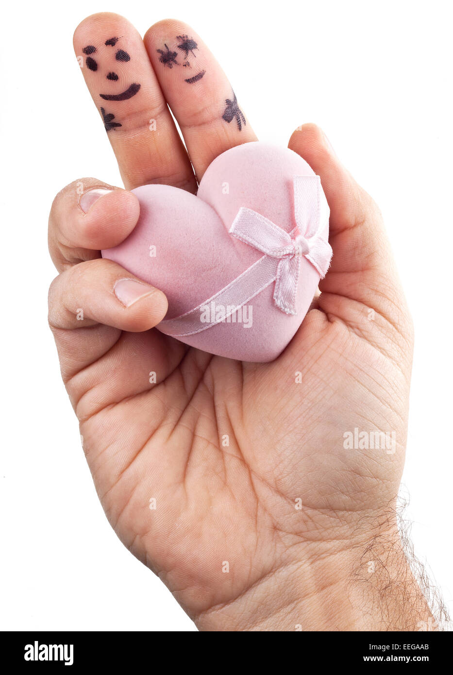 Couple painted on man's fingers and gift box in the form of heart. Stock Photo