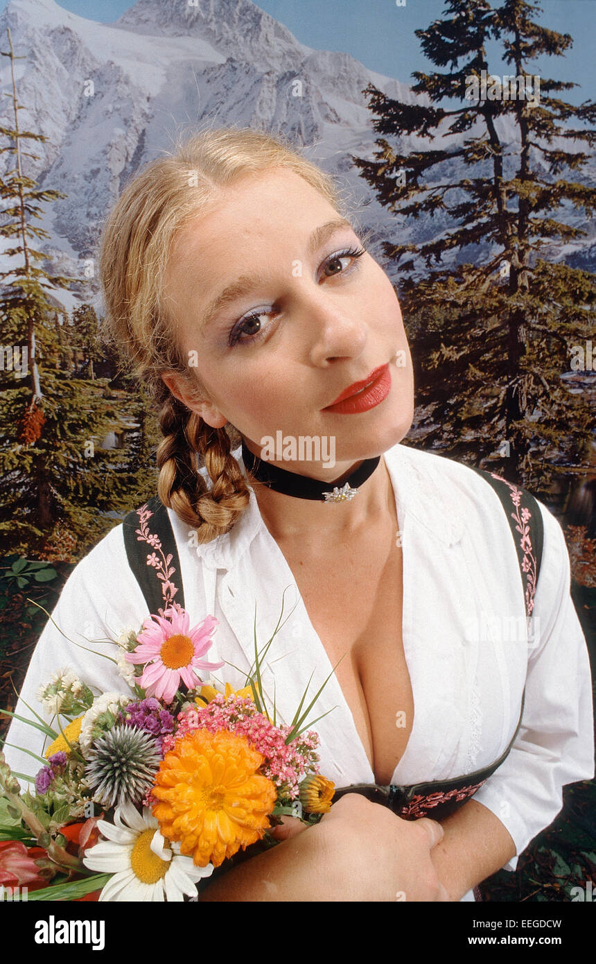 Hamburg, Germany, woman in dirndl with a bouquet of flowers Stock Photo