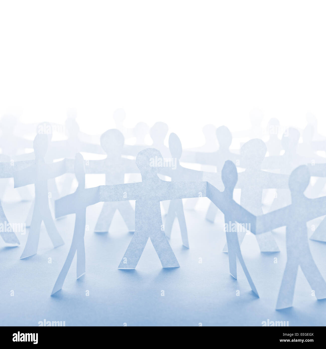 People Paper Cut Chain as Crowd or Teamwork Abstract Concept with White Copy Space Stock Photo