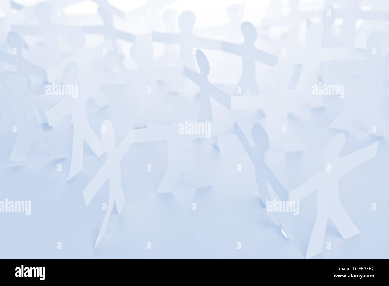 People Paper Cut Chain as Crowd or Teamwork Abstract Concept. Stock Photo