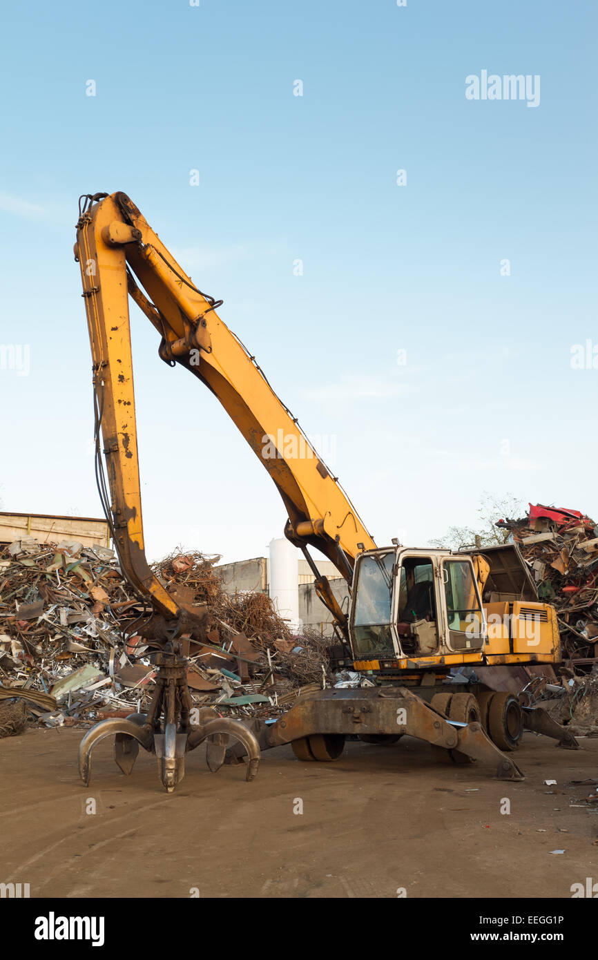 side view of crane in junkyard with clear blue sky Stock Photo