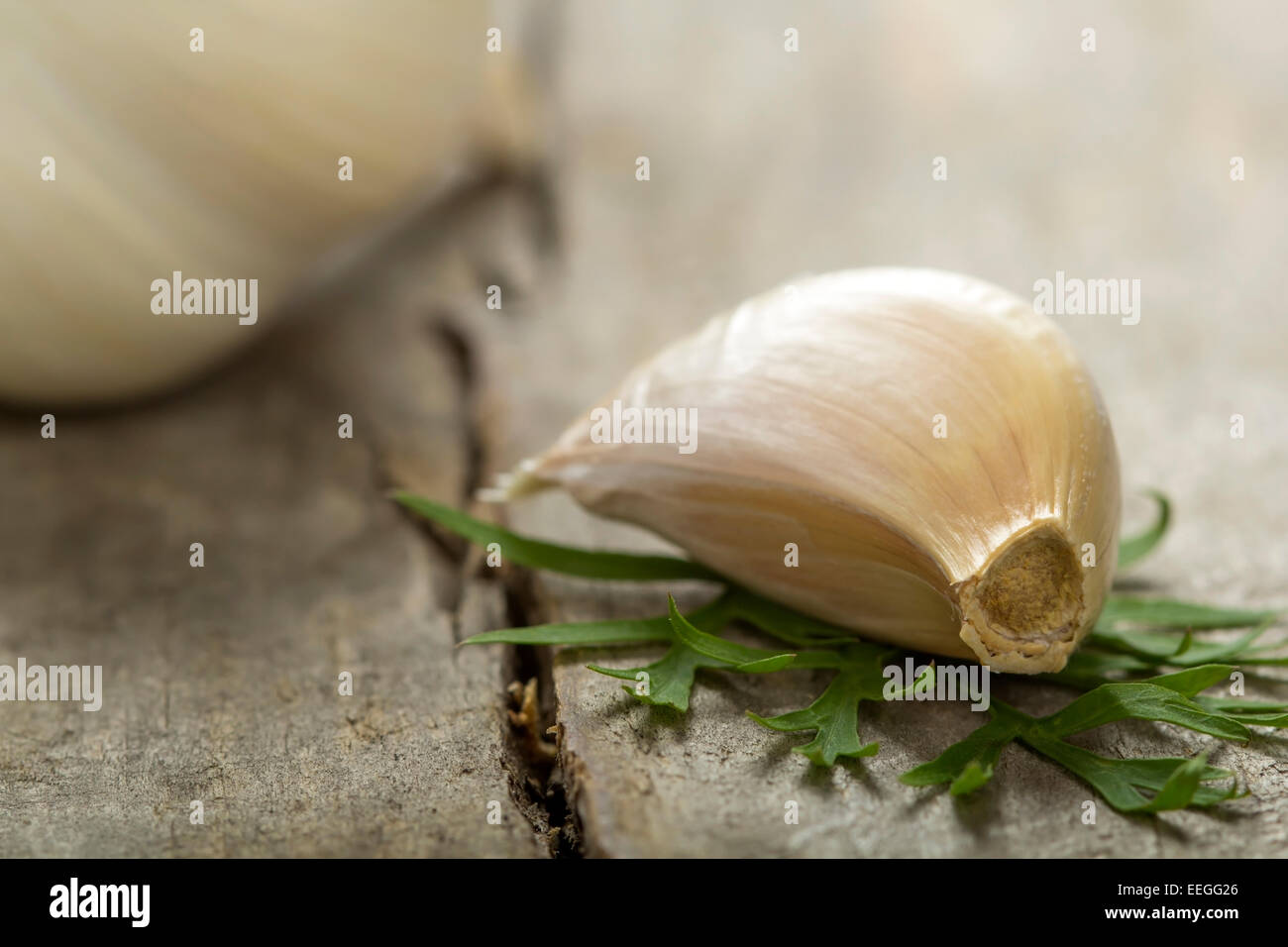 Garlic bulb and cloves over wood background Stock Photo