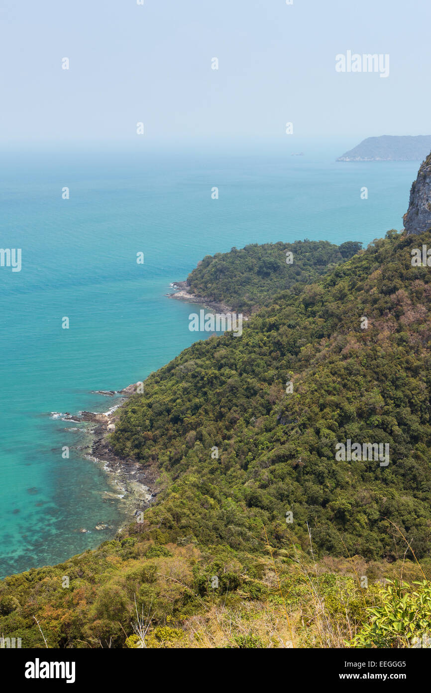 View of lush and hilly island, coastline and ocean from above at the Angthong (Ang Thong) National Marine Park in Thailand. Stock Photo