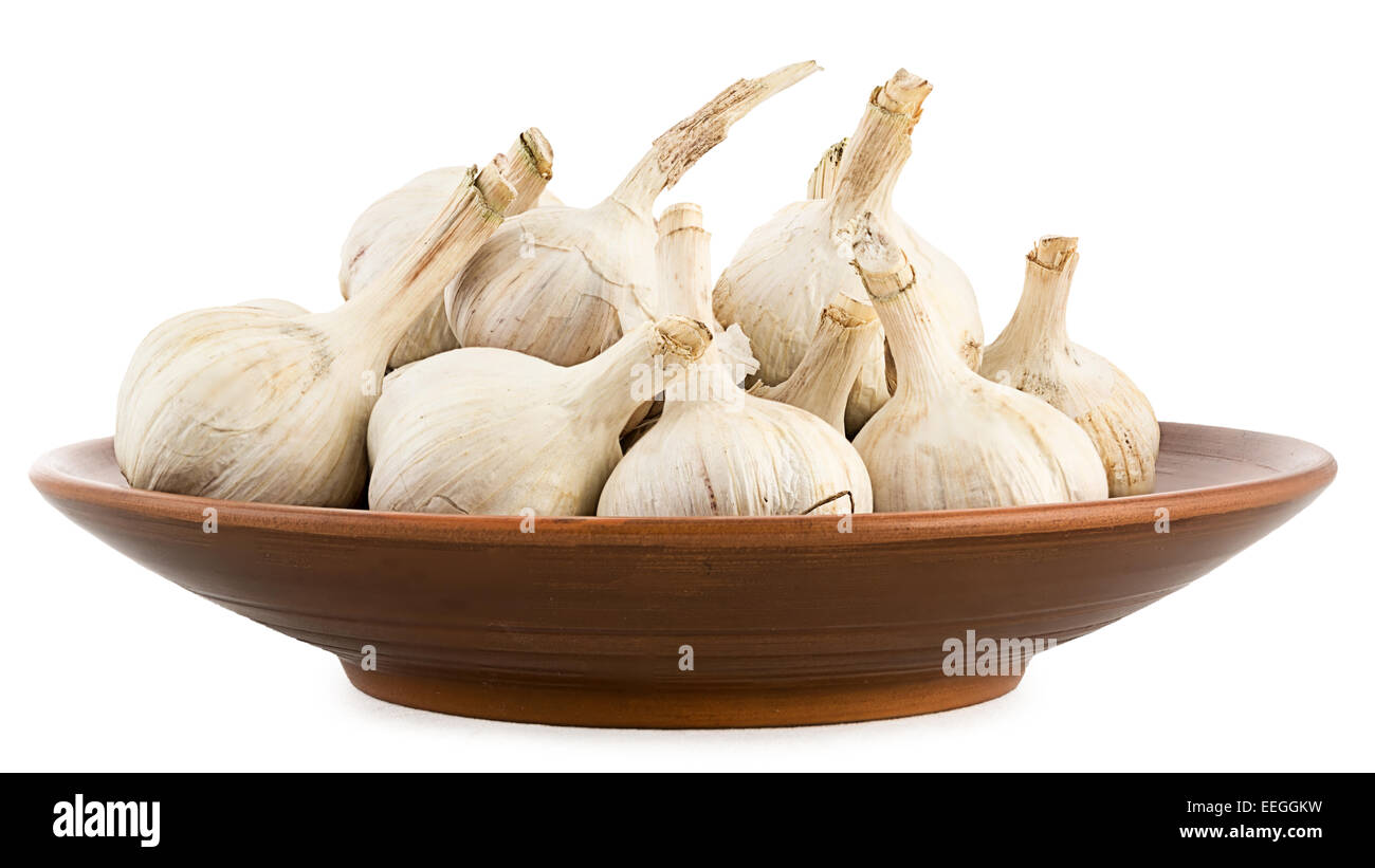 Fresh garlic in a clay pot. Isolation on a white background and folding of several images with different focus Stock Photo