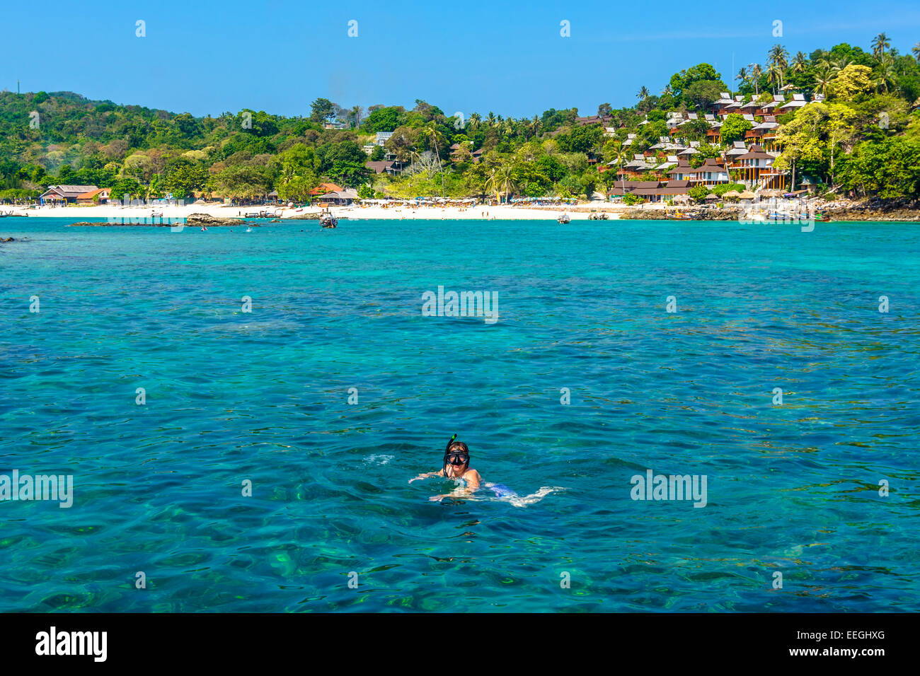 Tourist in the Adaman sea , Thailand snorkeling in exceptionaly clear water with underwater colourful coral and exotic fish Stock Photo