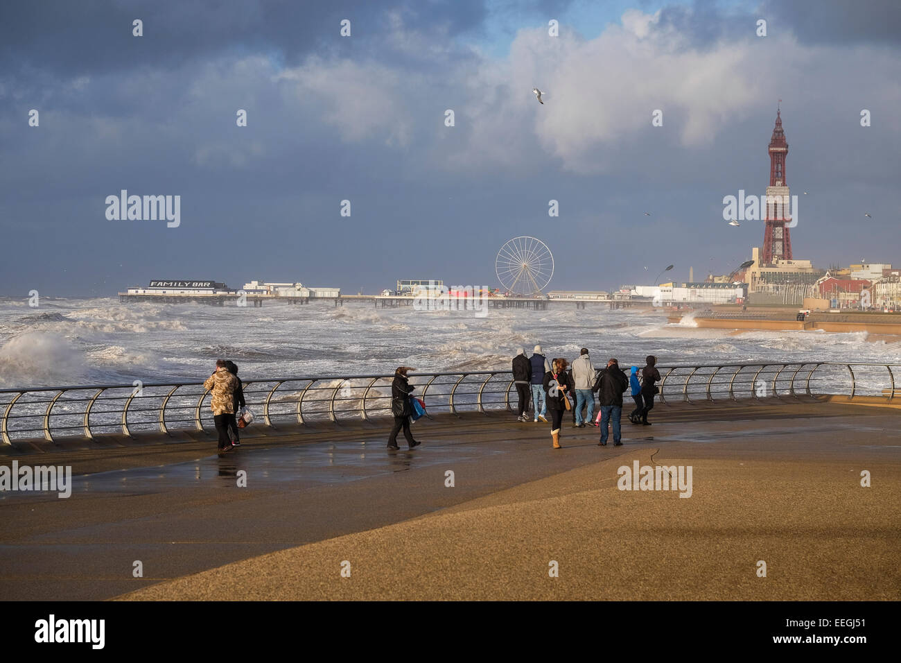 Blackpool, Lancashire: A bracing walk along Blackpool's promenade during gales and high-tide. Stock Photo