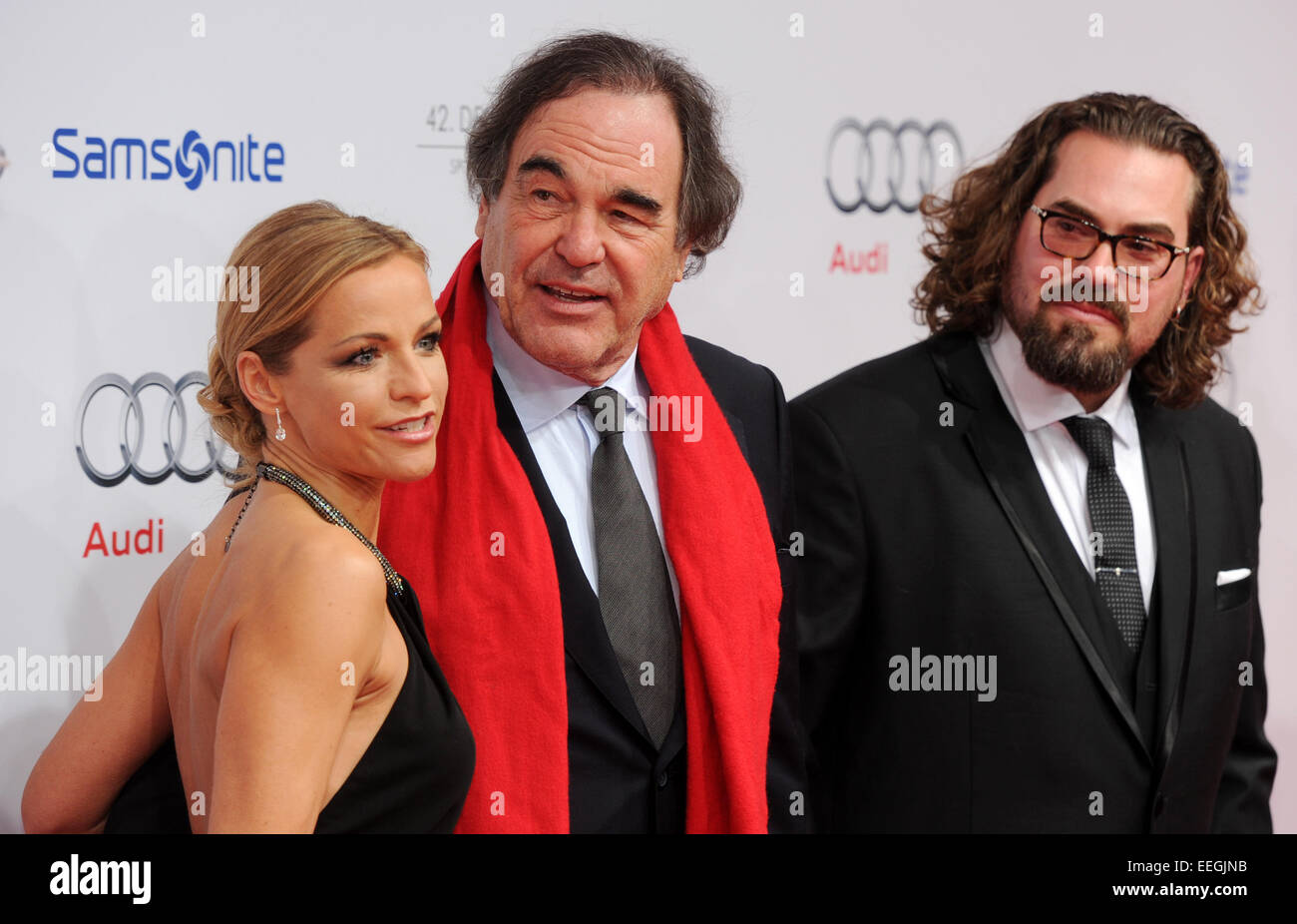 Munich, Germany. 17th Jan, 2015. US movie director Oliver Stone (C), producer Philip Schulz-Deyle (R) and female company arrive at the 42th German Film Ball at the Hotel Bayerischer Hof in Munich, Germany, 17 January 2015. PHOTO: Tobias Hase/dpa/Alamy Live News Stock Photo
