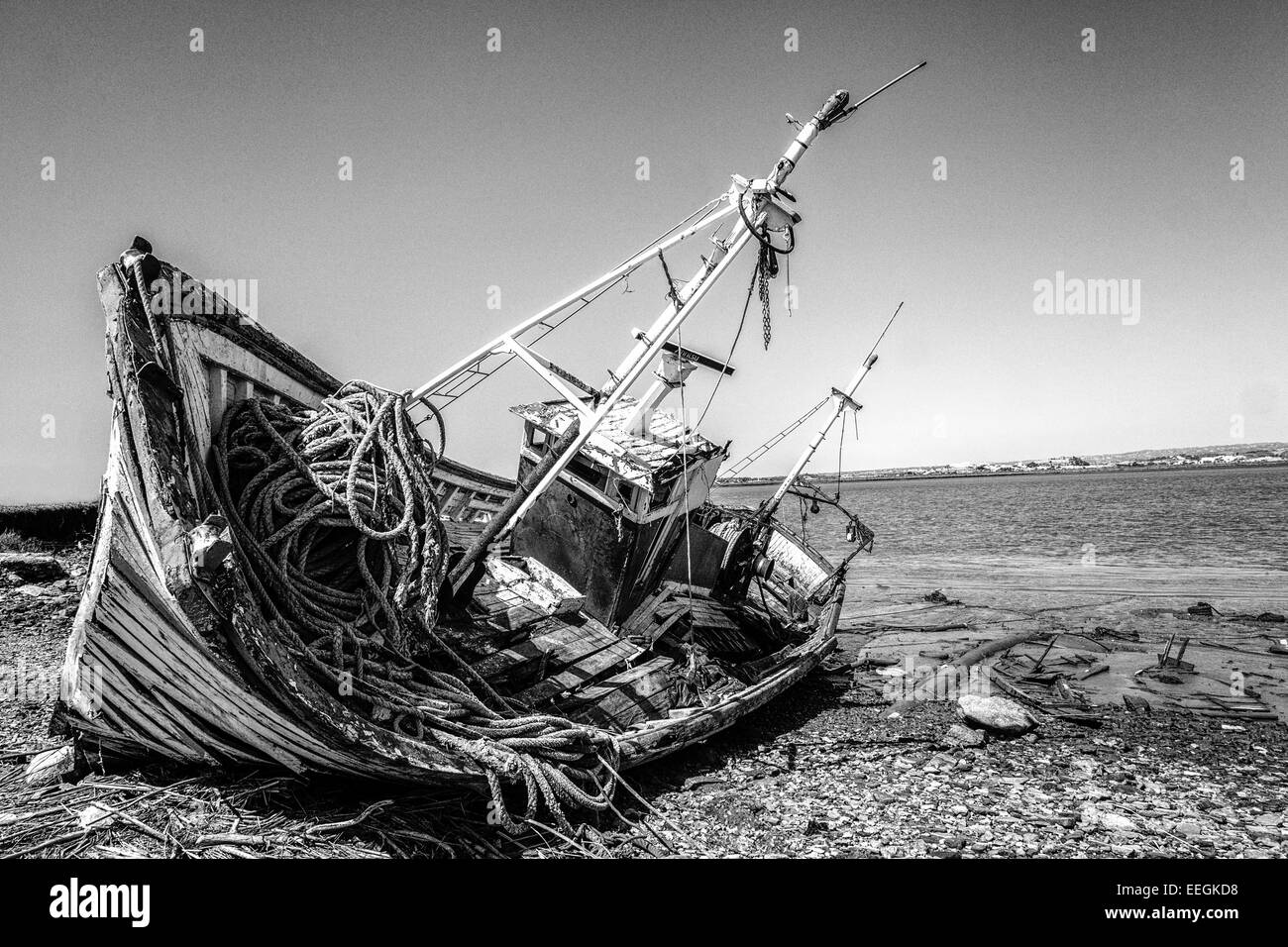 Beyond the need for repair; aged and worn-out old fishing vessel laying on the beach. Stock Photo