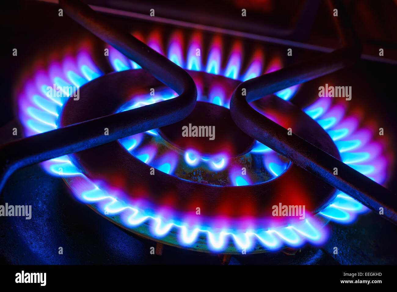A gas wok burner with blue and red flames. Stock Photo