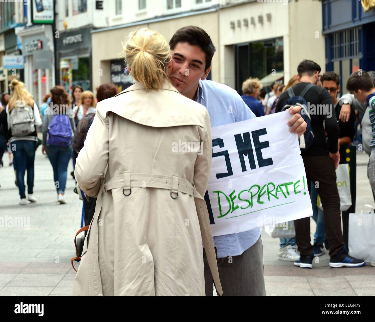 Argentinean You Tube prankster & personality Santiago Cattaneo stands on Grafton Street with a sign Kiss Me I'm Desperate! while being secretly filmed by a friend nearby for one of his online viral videos  Featuring: Santiago Cattaneo Where: Dublin, Ire Stock Photo