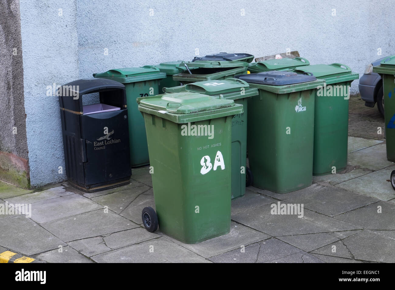 A collection of domestic green wheelie bins in the street. North Berwick, East Lothian, Scotland. Stock Photo