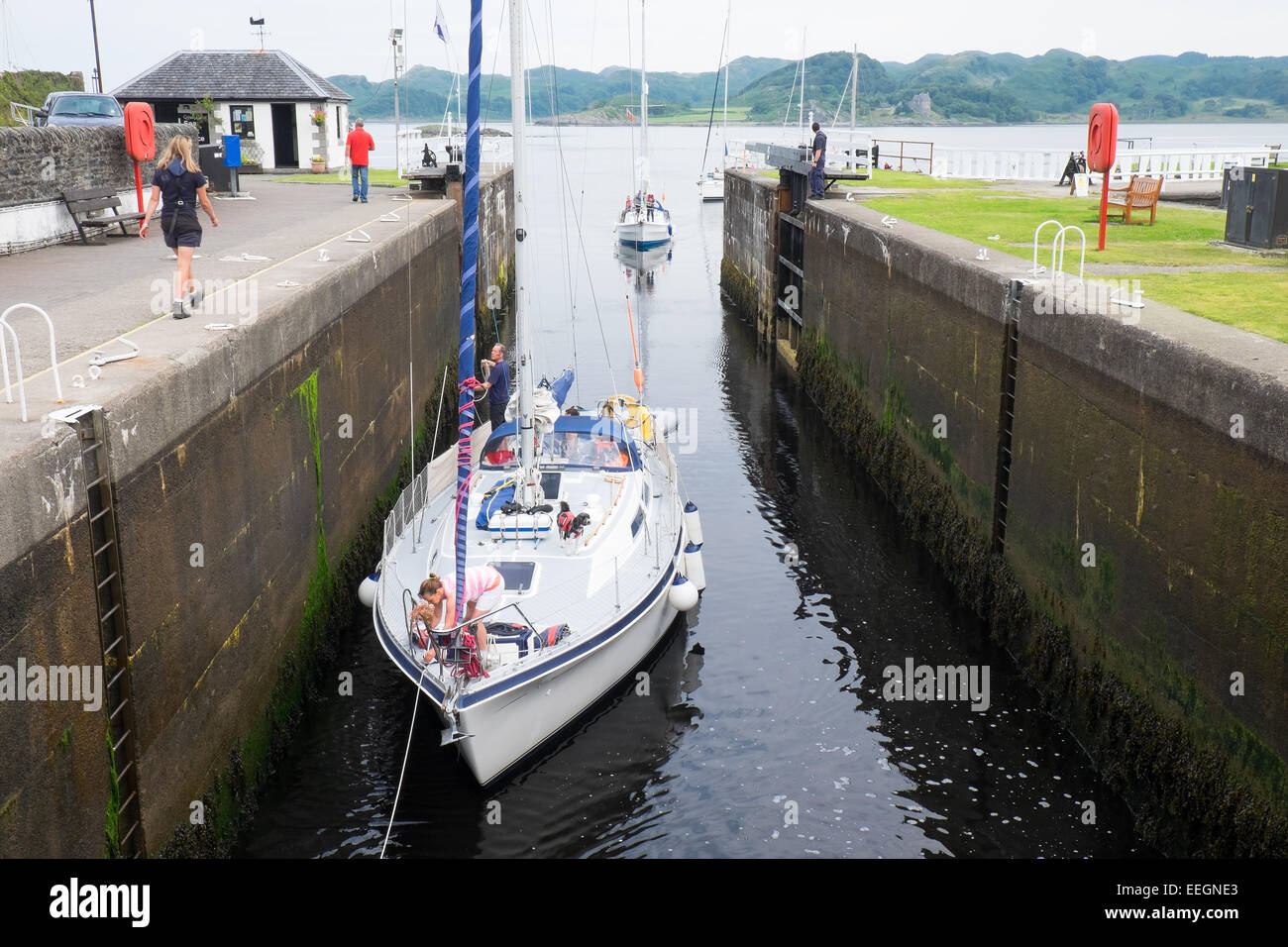 A yacht entering the first lock at Crinan on the Crinan Canal in Scotland. Stock Photo