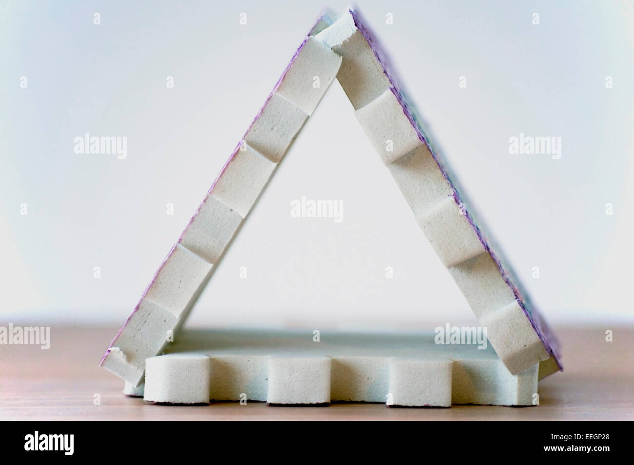 Close up of three foam puzzle pieces arranged to create a triangle