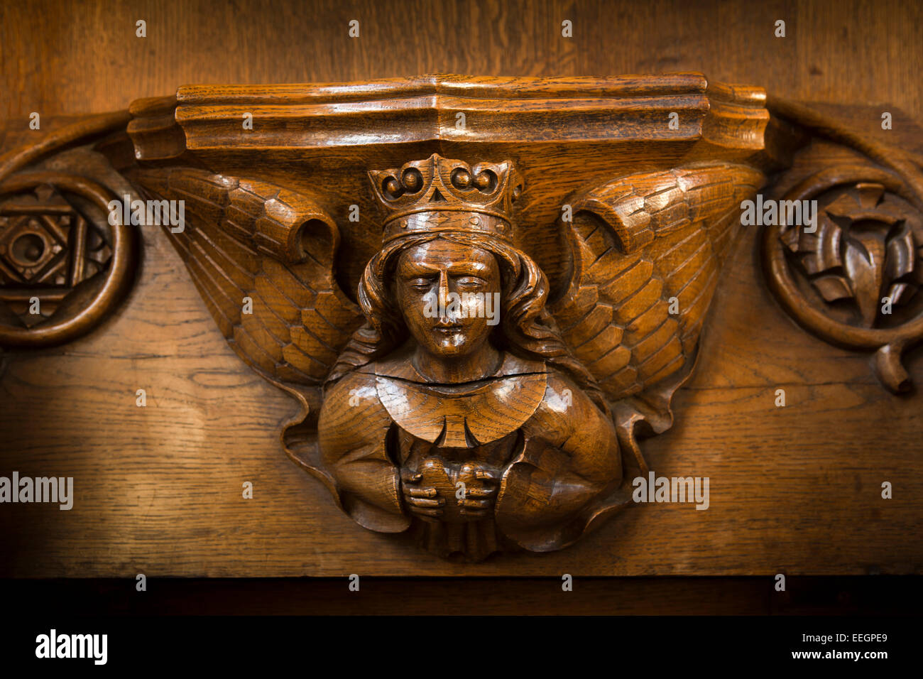 UK, Derbyshire, Tideswell, Church of St John the Baptist, misericord of carved angel holding heart Stock Photo