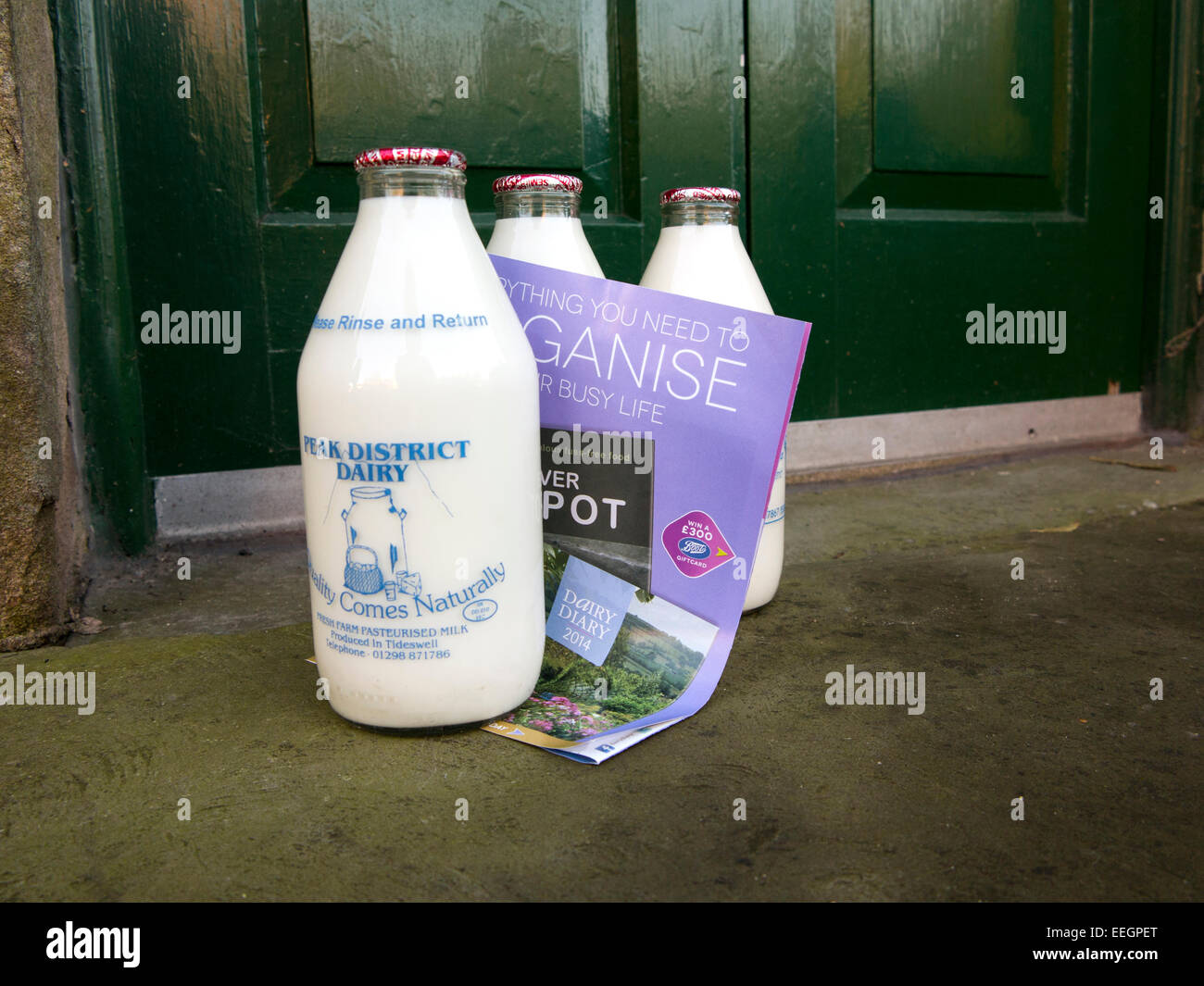 UK, Derbyshire, Peak District, Tideswell, local farm’s daily fresh milk delivery, bottles on doorstep Stock Photo