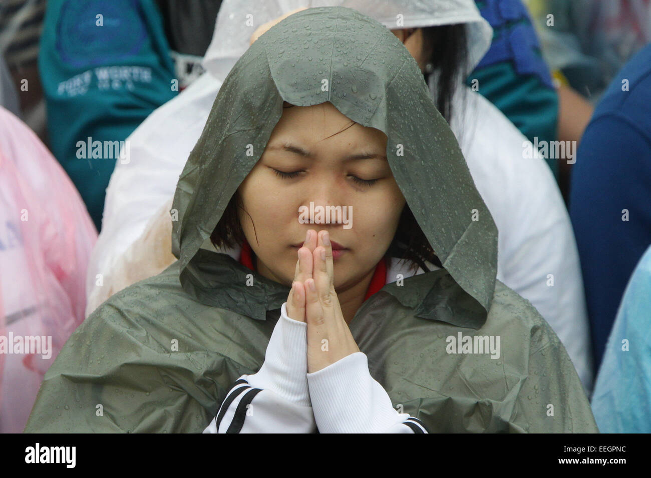 Manila, Philippines. 18th Jan, 2018. A woman closes her eyes during Pope Francis closing mass at the uirino Grandstand, Rizal Park on January 18, 2015. The mass was attended by an estimate of 6-7 million people. Photo by Mark Cristino. Credit:  Mark Fredesjed Cristino/Alamy Live News Stock Photo