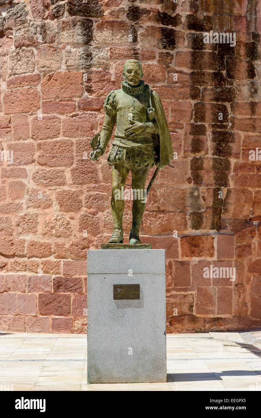 Miguel de Cervantes statue in front of Big Tower of the Great Prior (or Torreon of Don Juan de Austria) in Alcázar de San Juan Stock Photo