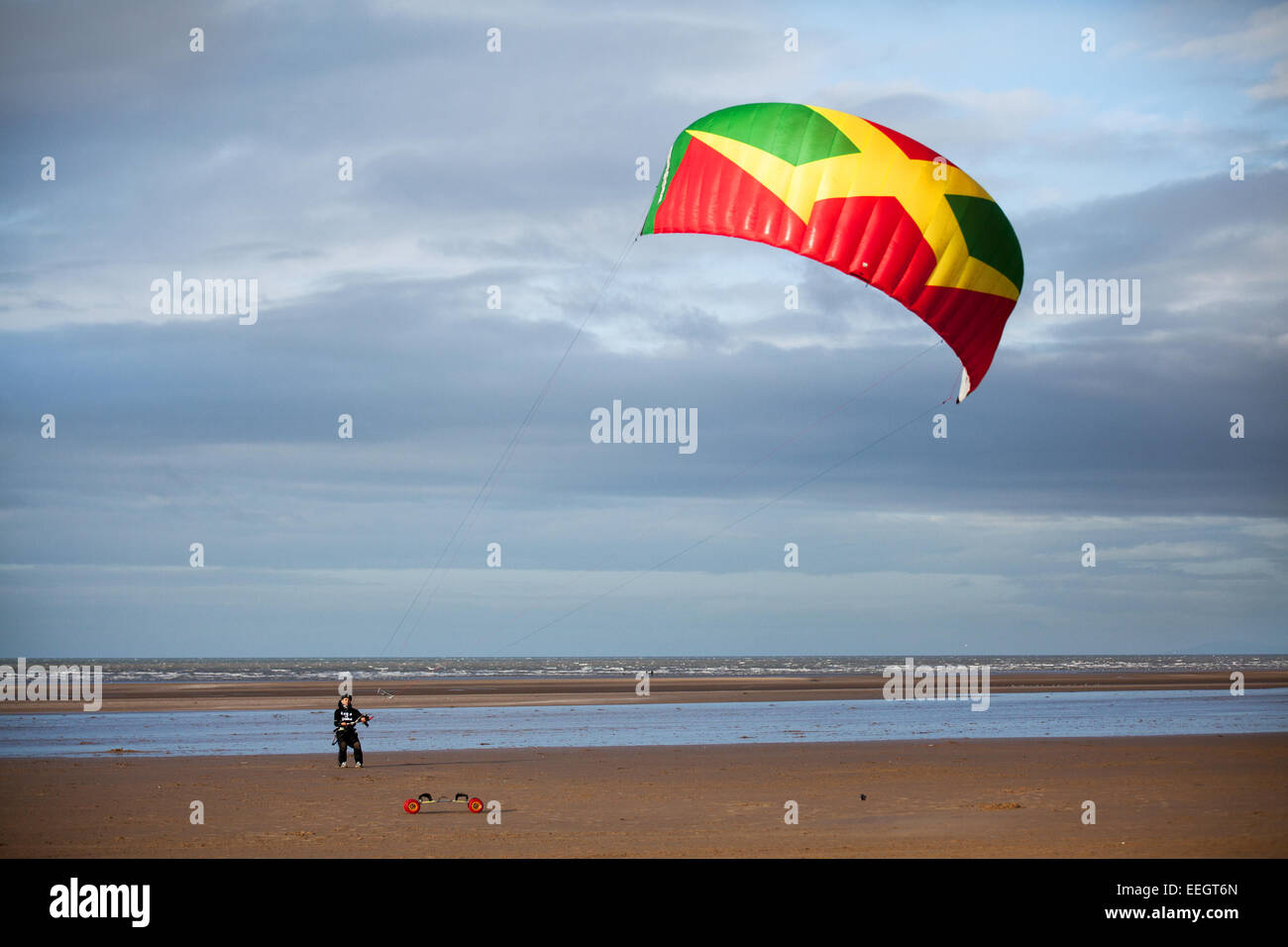 Southport, Merseyside, UK. 18th Jan, 2015. Carl Kirton, from Preston landboarding at his favourite spot on Ainsdale beach in stiff northerly winds, on the north-west coast. Carl is the team rider for Peter Lynn Kiteboarding in Preston, and won 2nd & 3rd in various disciplines in the final round of the British Championships on the 12th-14th of September 2014 held in North Devon. Credit:  Mar Photographics/Alamy Live News Stock Photo