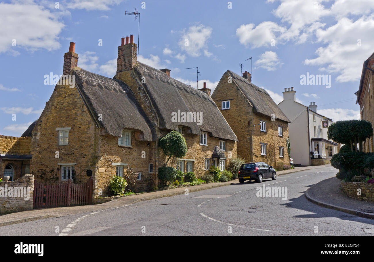 Row Of Thatched Cottages In The Pretty Northamptonshire Village Of