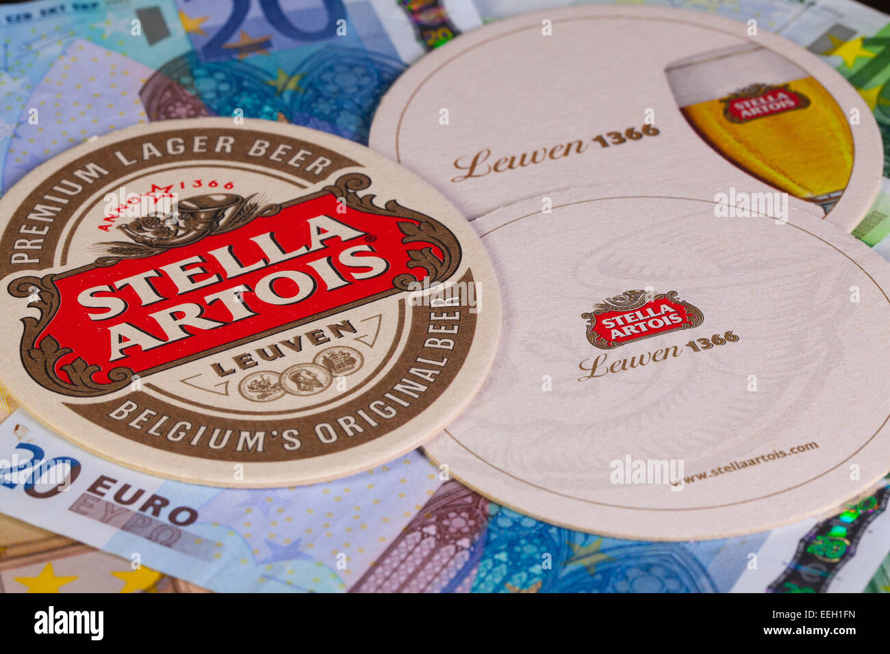 ENGLAND,LONDON - November 11, 2014:Beermats from Stella Artois and eur banknotes.It has been brewed in Leuven, Belgium, since 19 Stock Photo