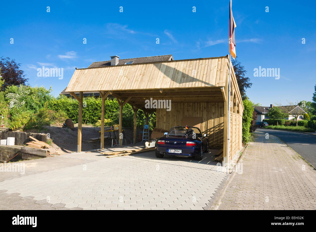 Solar Carport 'Sunport' providing shelter and charging energy for two EV electric cars - here with a conventional BMW Z3 Stock Photo