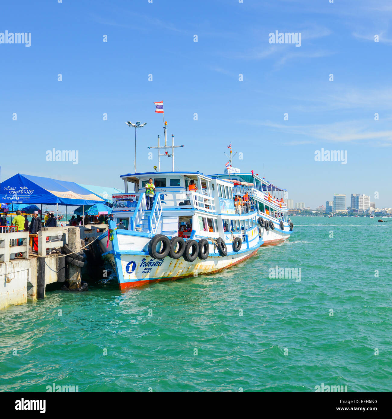 PATTAYA, THAILAND - DECEMBER 29 :  Passenger ship at Boat park for visitors to the harbor with coast of Pattaya city on December Stock Photo