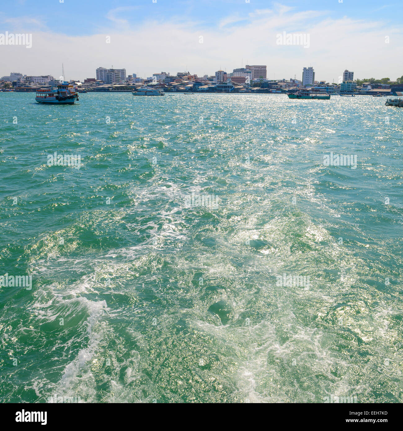 The wake of a boat as seen from the stern of a ship at coast of Pattaya city. Stock Photo