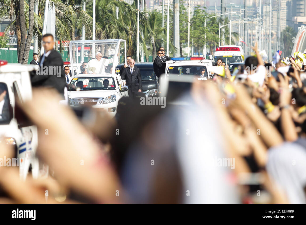 Baclaran, Philippines. 19th Jan, 2015. Pope Francis waves to the people on his motorcade to the Villamor Airbase in Baclaran, Paranaque on Monday, January 19, 2015. Pope Francis is on his way back to the Vatican after a 5-day visit to the Philippines. Credit:  Mark Fredesjed Cristino/Alamy Live News Stock Photo