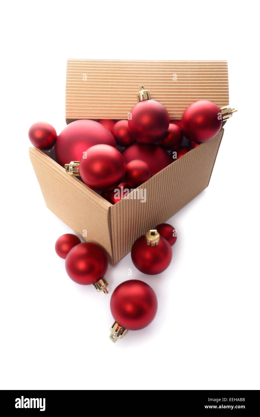 Christmas decorations: group of red Christmas balls in a kraft corrugated cardboard box, Christmas tree decorations, isolated on Stock Photo