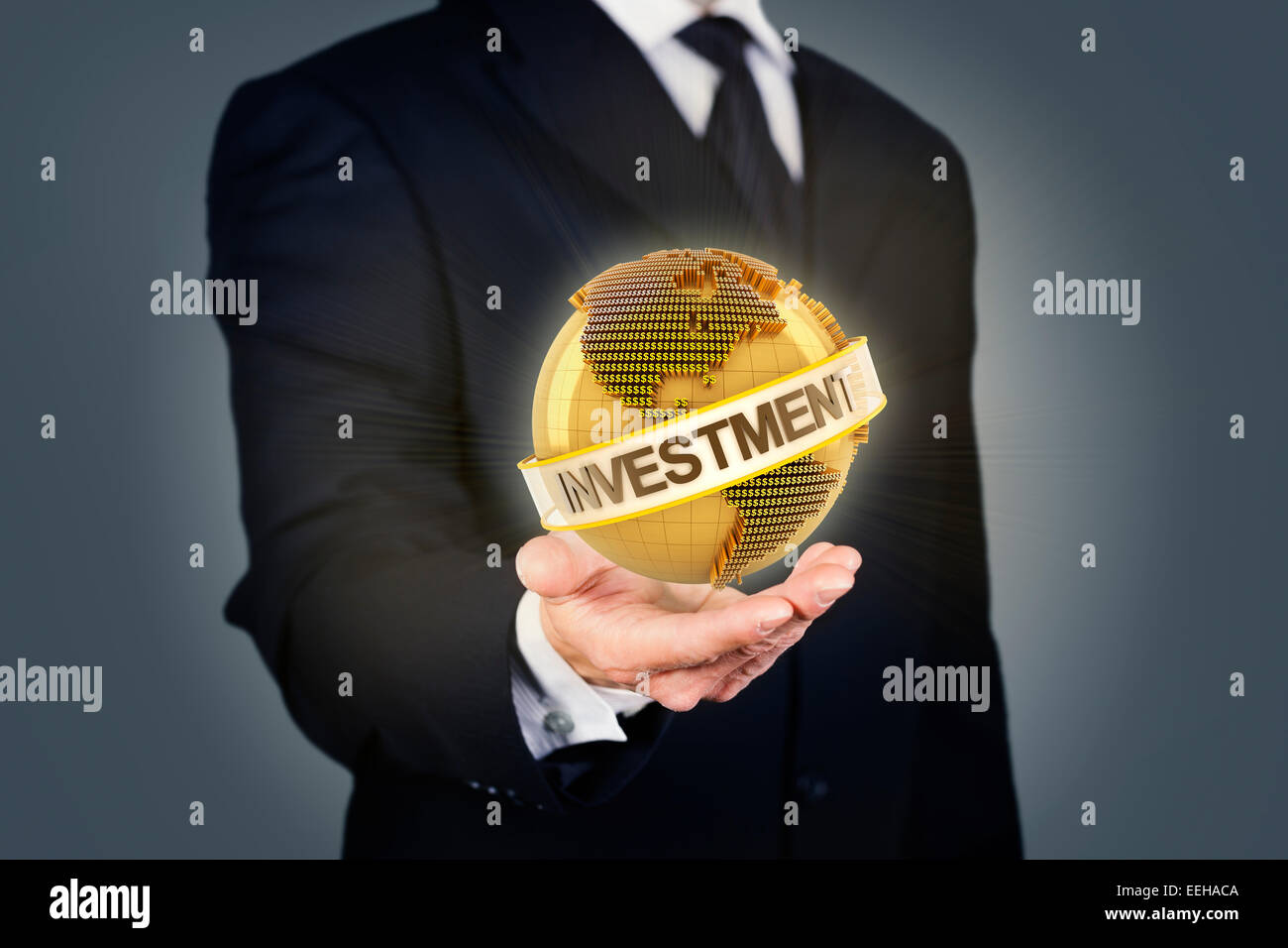 Businessman holding a golden globe with investment text Stock Photo