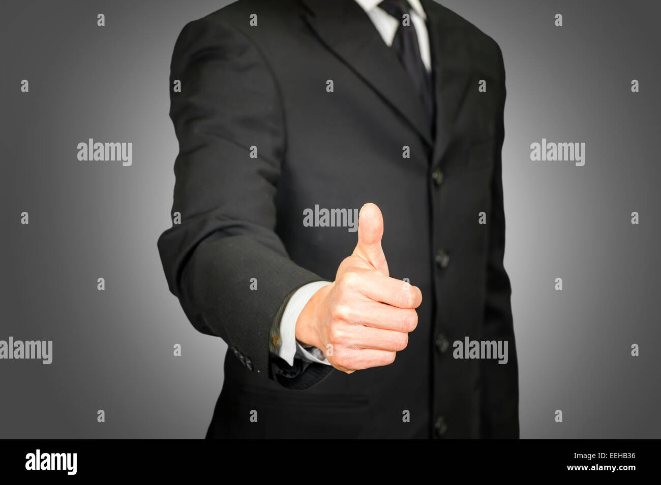 Businessman with thumbs up gesture Stock Photo