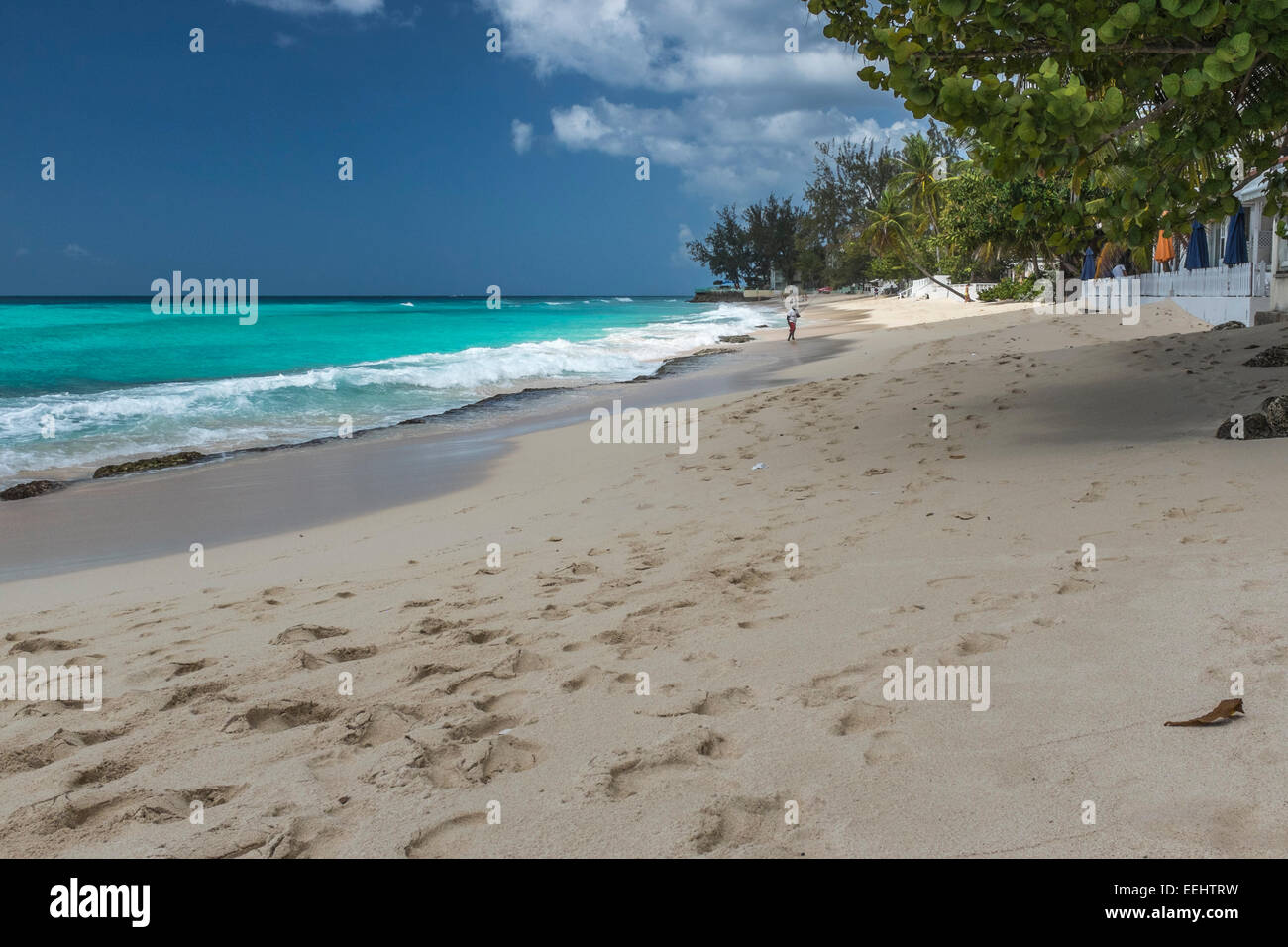 Tourists on Worthing Beach on the south coast of the Caribbean island of Barbados in the West Indies - EDITORIAL USE ONLY Stock Photo