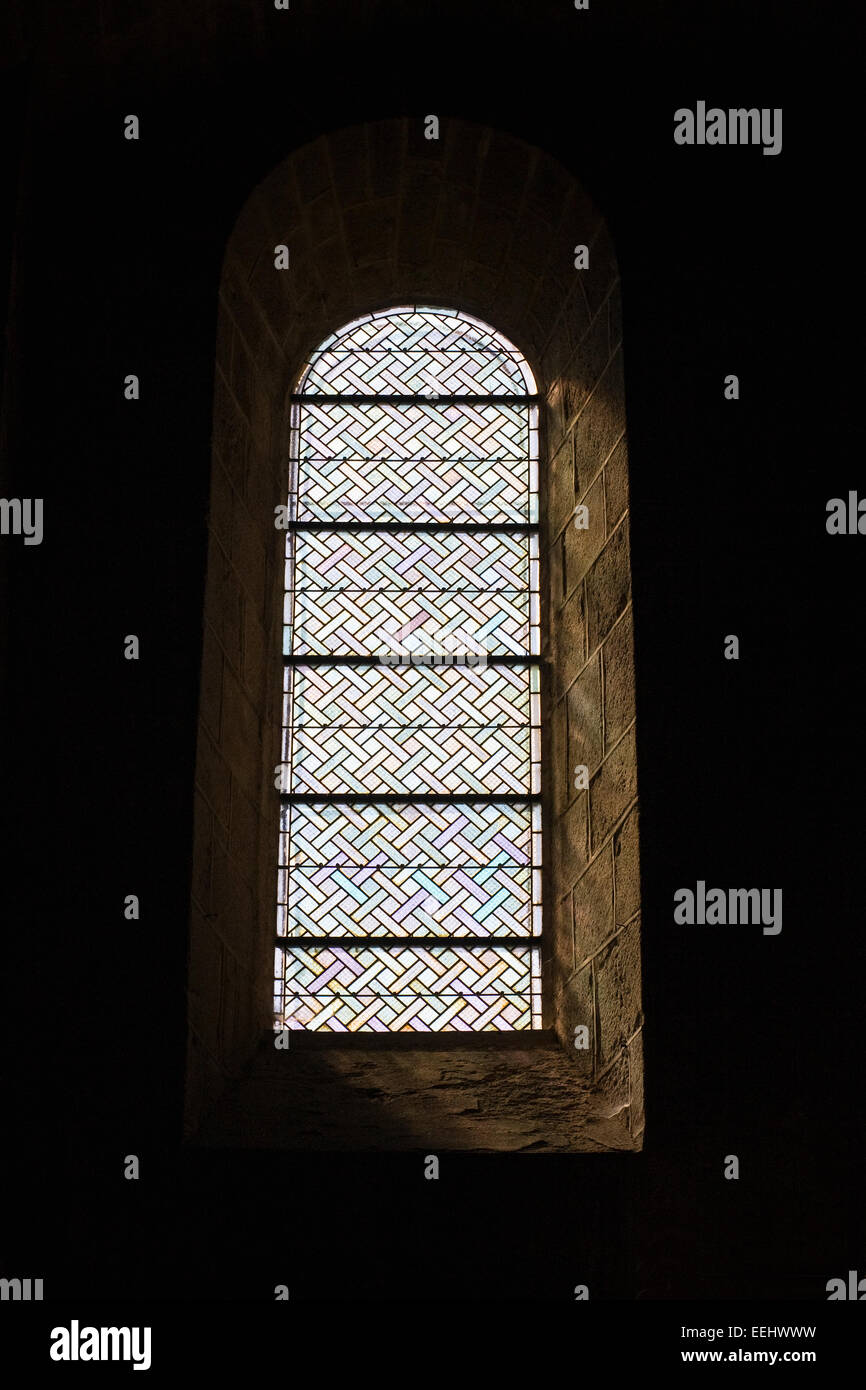 Simple stained glass window Abbatiale St. Pierre St. Paul de Solignac. Stock Photo